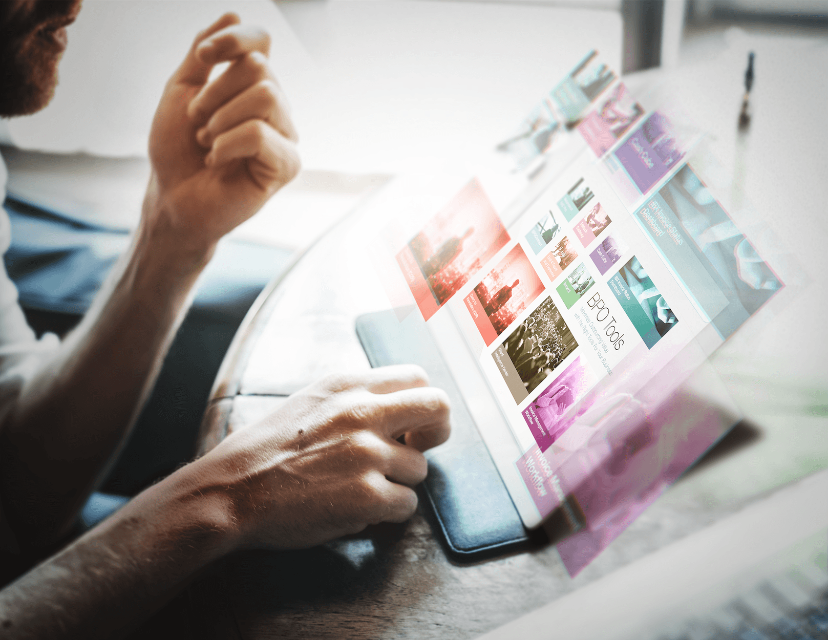 Hands holding a tablet with a colourful interface design